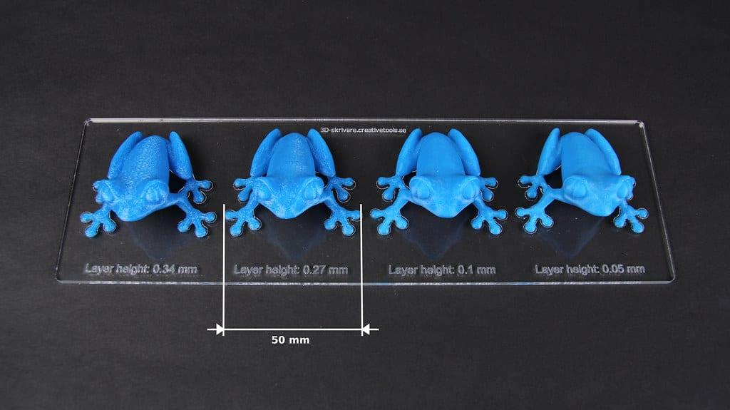 Test plate of small FDM-printed parts showing the same shape printed at several different layer thicknesses