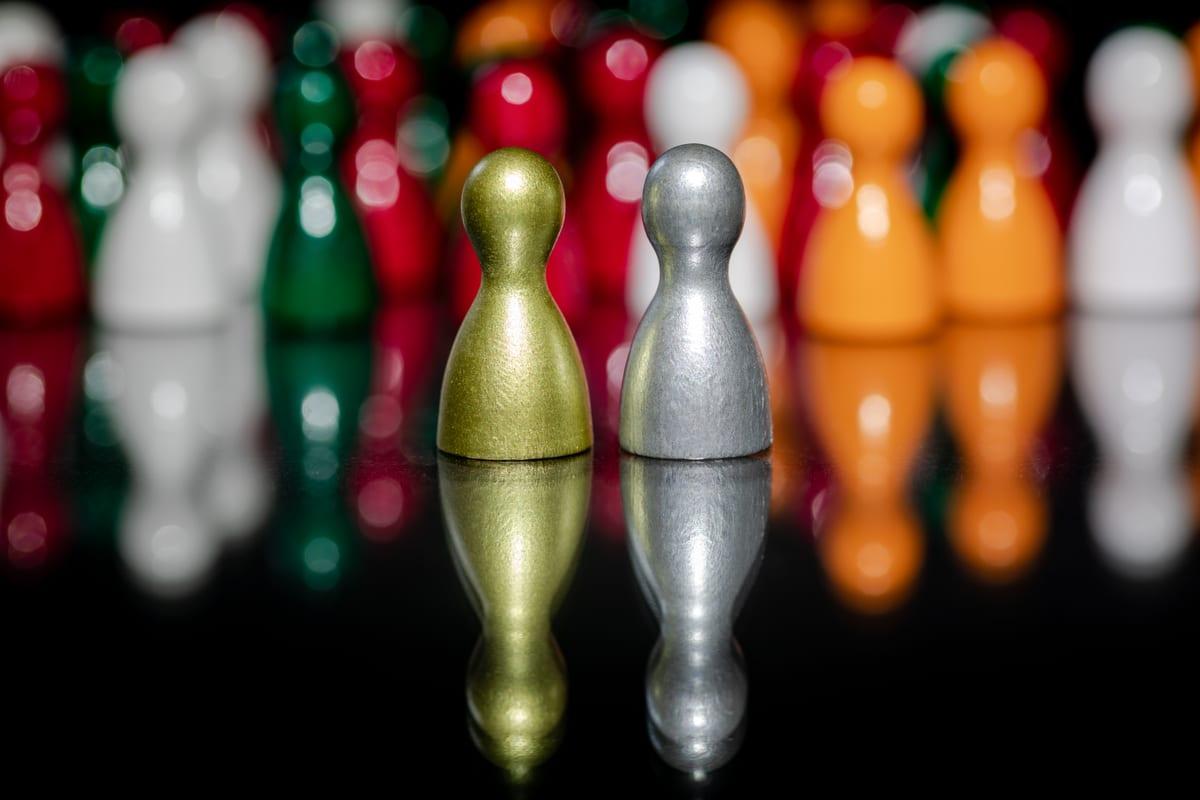 Loose wooden board game player tokens in several colours, unsorted