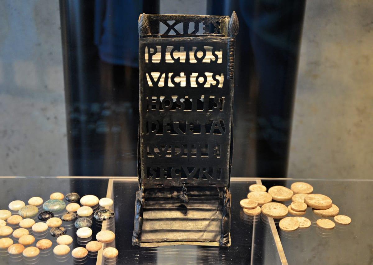 A Roman bronze dice tower from the fourth century AD displayed in a museum