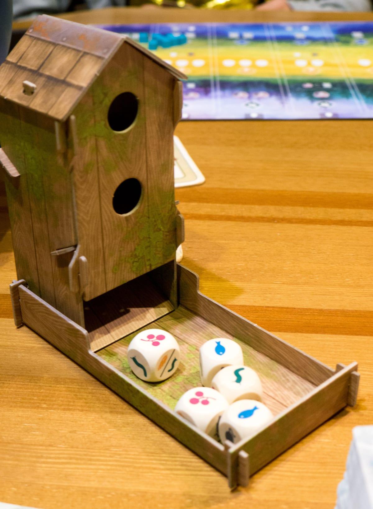 A birdfeeder-shaped dice tower used as a component in the board game Wingspan