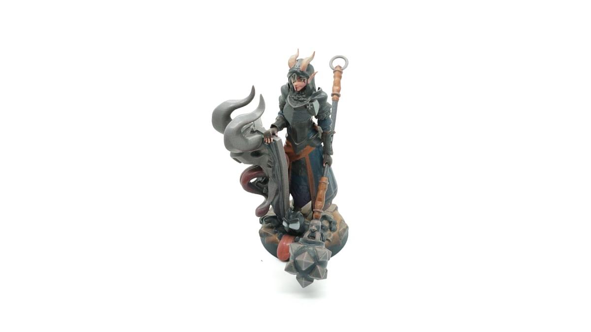 A painted 3D printed fantasy warrior miniature for tabletop gaming on a white background