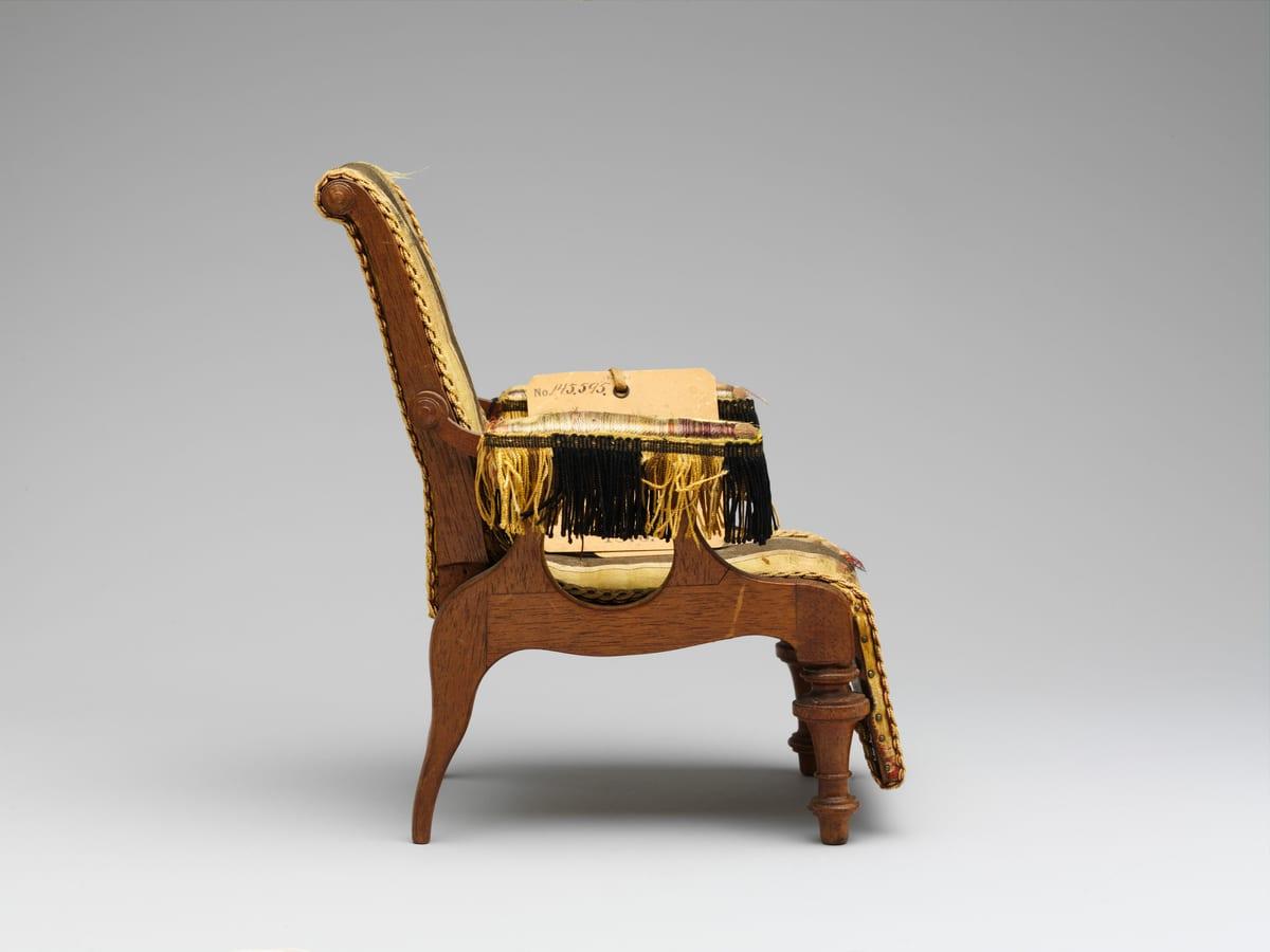 Nineteenth-century wooden patent model of an adjustable reclining chair, photographed from the side
