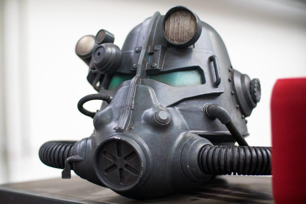 A finished 3D printed power armour helmet prop, painted gunmetal grey with weathered edges, flat panels and moulded hose fittings