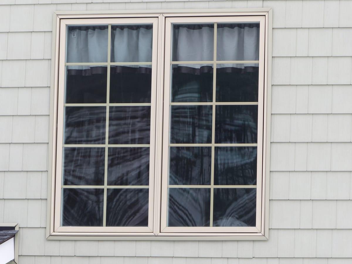 Modern casement window cranked open from the inside of a house